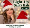 Set of 2 Light-Up Santa Hats &ndash; Multiple Flashing Modes & Steady-On Option
