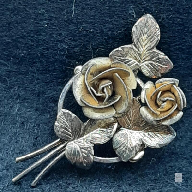 Two-Rose Floral Bouquet Brooch with Textured Leaves<br/><br/>Light surface wear and discolouration are visible.