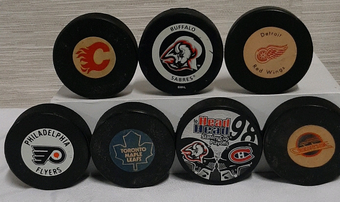 7 Vintage Hockey Pucks