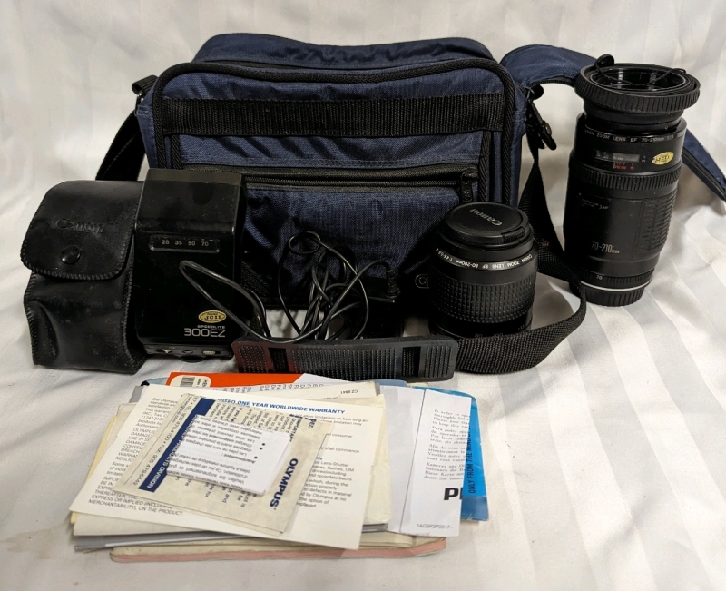 Optex Camera Carrying Case, 2 Canon Lenses, a Canon Flash and Instruction Manuals.