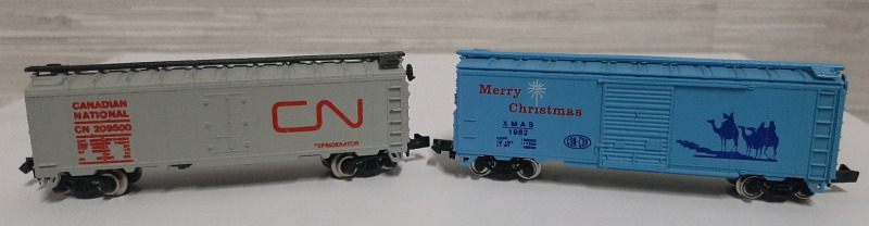 Vintage, 1 CN Boxcar and 1 Christmas Boxcar. Both are N Scale