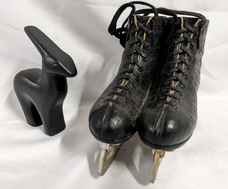 Decorative Ice Skates and Earthenware Animal Statue.