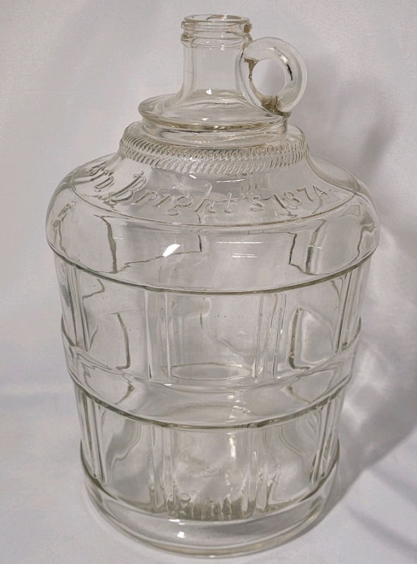 Bright's " 1874 " Clear Glass Jug , measures 11 3/4" tall