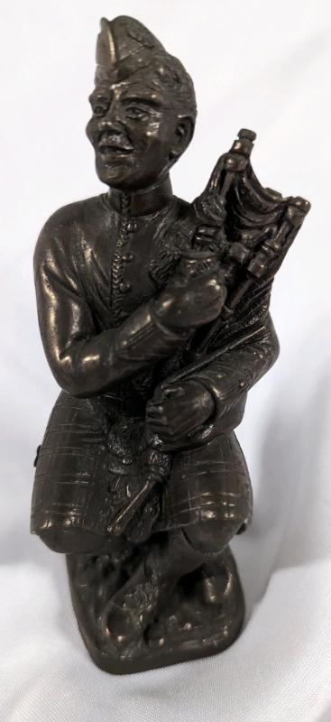 Vintage statue of Scottish Bagpiper.