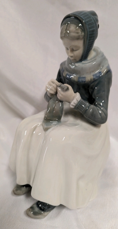 Royal Copenhagen Model Number 1711. "Armager Woman Sewing"