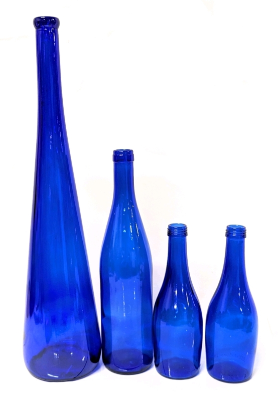 A Quartet of Cobalt Blue Bottles in a Small Plastic Crate