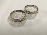 Sterling Cut Crystal Open Salts pair of antique cut crystal open salts with Step Cuts that have a Sterling Silver rim. About 1 1/2 inch tall. A few light dents on the rim.