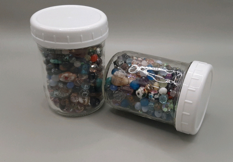 Two Glass Jars Filled with Glass Beads