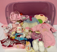 Big lot of baby doll clothes and accessories in a purple storage box