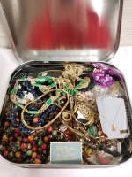 Cookie tin of assorted jewelry