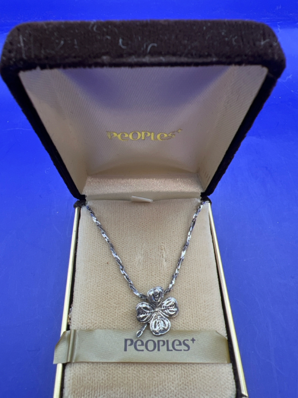 Sterling Silver 925 fancy 20 inch stamped chain holds a stemmed four leaf lucky clover. Four leaf etched clover is approximately .75 inches with back bale. Presented in a vintage People Jewellers Box.
