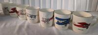 7 (Seven) Airplane Mugs.