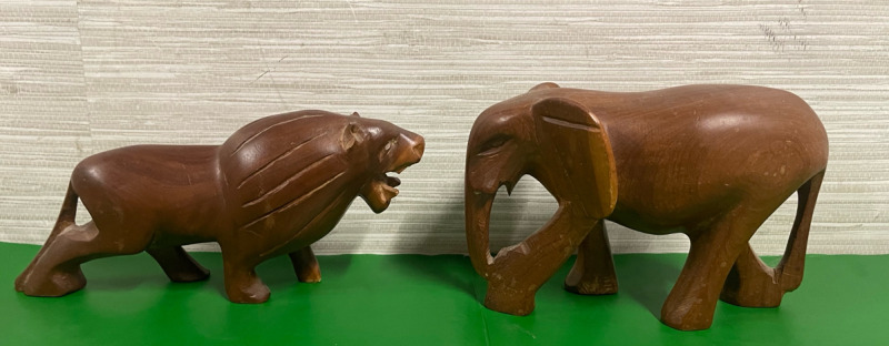 Fierce wooden lion and gentle wooden elephant figures for decoration