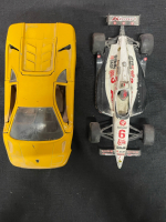 Two toy cars - one Lamborghini and one racing car