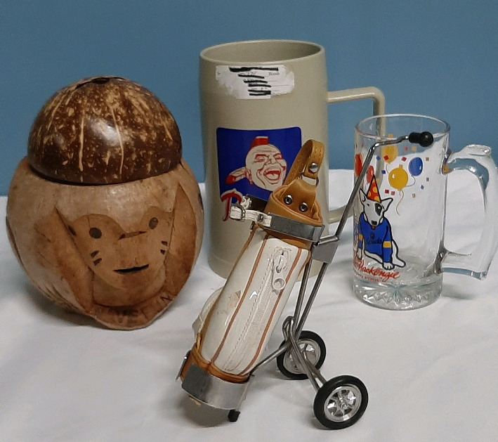 Vintage Beer Mug Celebrating Spud Another Beer Holder Made out of a Coconut and a Beer Mug from the Atlanta Braves Added in is a Golf Cart Pencil Holder