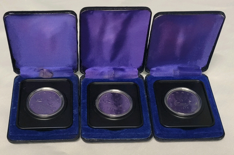 1975 Canadian Uncirculated One Dollar Coins in Cases . Three (3) Coins