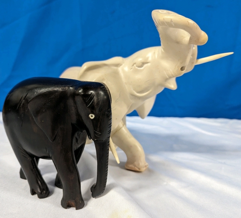 2 Elephant Statuettes. Both missing right tusk. Largest measures 11" by 6" by 7.25"