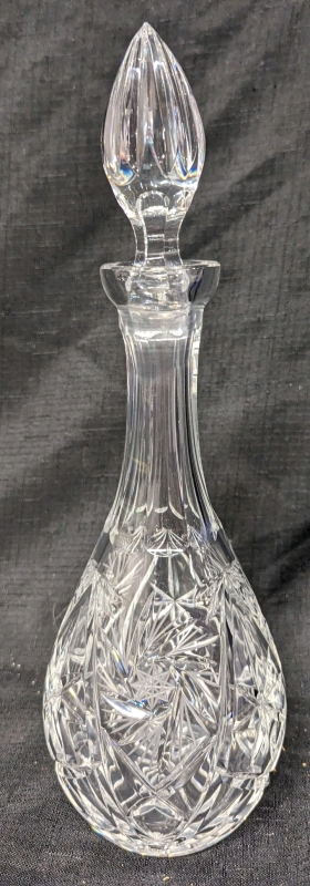 Crystal Decanter with Pinwheel Pattern. Measures 14" Tall With Stopper. No Chips or Cracks Noted.