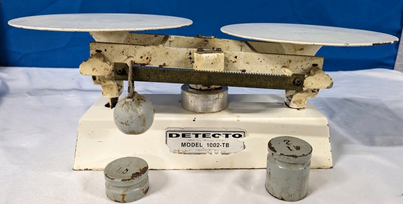 Detecto Model 1002-TB Scale. Capacity of what Appears to be 8 Lb. Comes with 2 and 1 Lb Weights. 20" Wide.