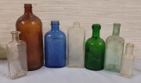 Vintage Coloured & Clear Glass Bottles . Seven (7) Bottles . Measures 4.5" - 9.5" Tall