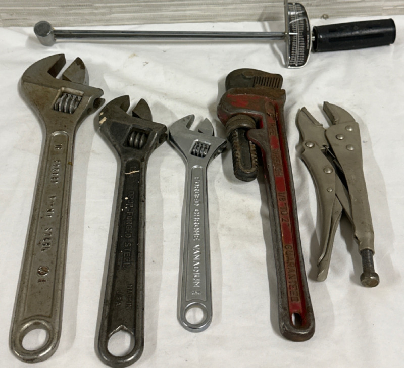 6 Piece Wrench Lot Including 3 Adjustable Wrenches 1 Pipe Wrench 1 Torque Wrench and a Pair of Vise Grips
