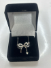 Certified Moissanite VVS Dangling from a Bow Pendant Sterling