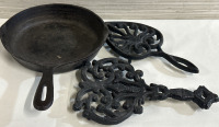 3 Vintage Cast Iron Pieces Including 8” Frying Pan & Two Footed Cast Iron Trivets