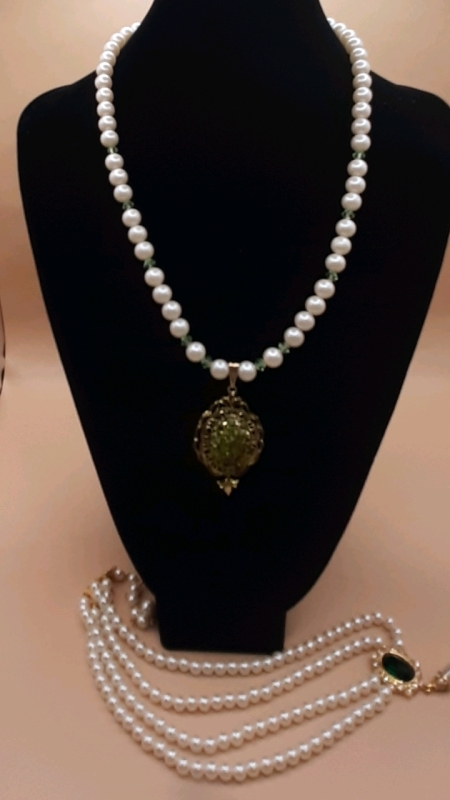 2 Vintage Faux Pearl Necklaces- The First Has Soft Green Beads Added to it a Goldtone Medallion with Green Stones in the Center, The Second is a 2 Tiered Necklace that Comes to a Goldtone Medalion with an Emerald Like Stone in the Center, Rhinestones and 