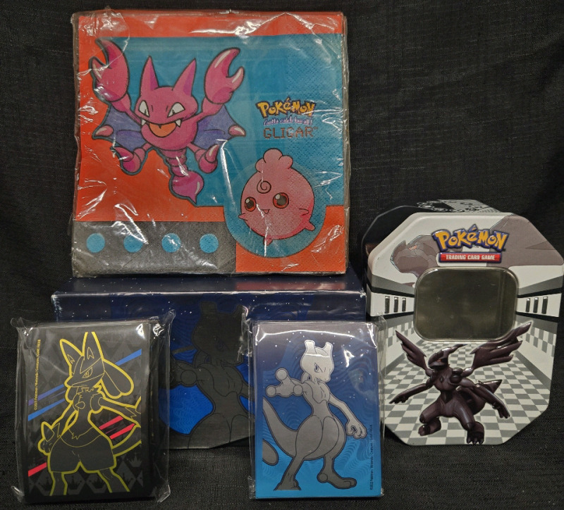 Assorted Pokémon Lot | Includes But Isn't Lmited To; 2 Pokémon Card Storage Containers 1 Cardboard & 1 Metal, & Pokémon Card Single Sleeves With Mewtwo Design