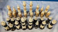 Assorted Chess Pieces Made of Natural Style Materials. King measures 5.75" Tall, with a 2.75" Diameter Base.