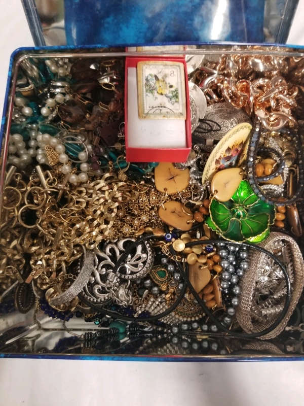 Cookie tin full of vintage jewelry