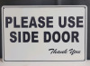 New - " Please Use Side Door " Tin Sign . Measures 11"×8"