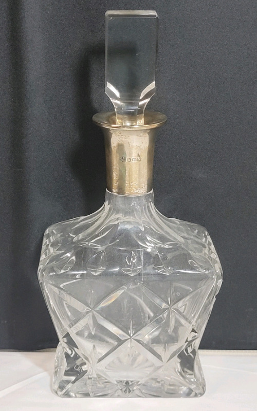 Vintage Glass Decantor w/Sterling Silver Neck Mount by Barker Bros Ltd Birmingham Dated 1937 . No chips or cracks to body , Stopper has chips on top and bottom . Measures 10 1/8" tall