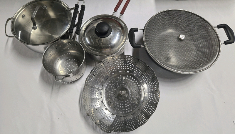 Assorted Cookware Lot, Includes But Isn't Limted To; Stainless Steel Soup Pot With Lid ( 9" Diameter 4" Tall ) A Pasta Strainer ( 5.5" Diameter 4" Tall ) Stainless Steel Sauce Pan With Lid ( 7.5" Diameter 3.5" Tall ) & Metal Pot ( 10.5" Diameter 3.5" Tall