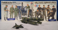 Assorted Military Toy Lot | ( 1 ) Sealed, Tamiya 1/35 Scale German Field Kitchen Scenery, ( 1 ) Tamiya 1/35 Scale German Tank Crew At Rest, ( 1 ) Small 3" Diecast Military Plane & 6" Long Military Missle Carrier Trailer