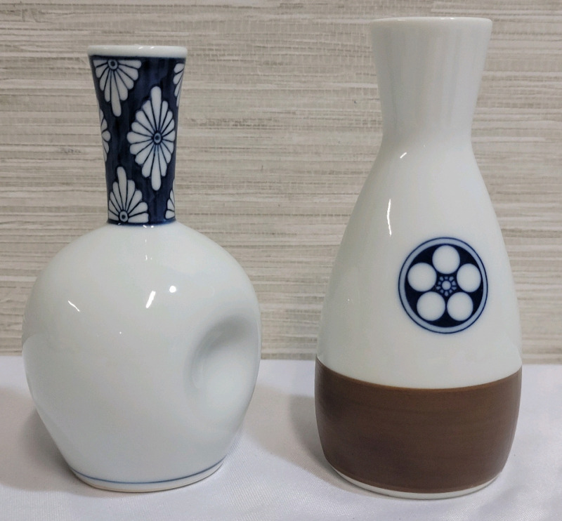 Two (2) Japanese Sake Bottles . Measures 4 3/4" & 5" tall . No chips or cracks