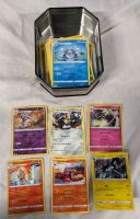 100+ Pokemon Cards with Tin. Common to Rare. Holographics Included.