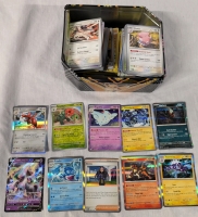 300+ Pokemon Trading Cards with Tin. Common to Rare. Holographics Present.