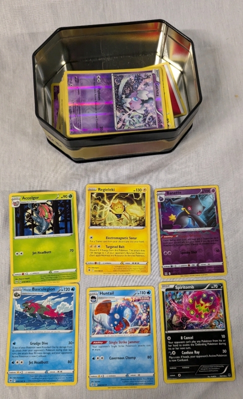 150+ Pokemon Trading Cards with Tin. Common to Rare. Holographics Present.