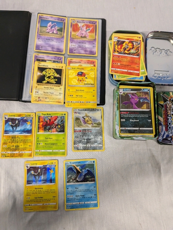 100+ Pokemon Trading Cards with 2 Tins and Binder. Commons to Rares. Holographics Included.