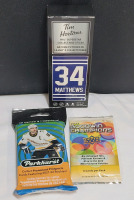 New - Sports Memorabilia Collector's Lot - 2021 - 22 Parkhurst NHL Hockey Trading Cards (sealed) , 2023 UD Goodwin Champions Trading Cards (sealed) & 2020 Tim Hortons Austin Matthews Mini Hockey Stick (sealed)