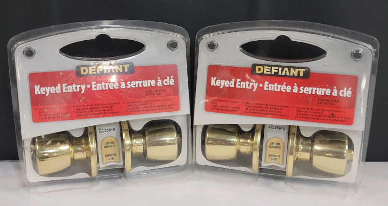 New - Defiant Keyed Entry Door Knobs , Polished Brass . Two (2) Door Knobs