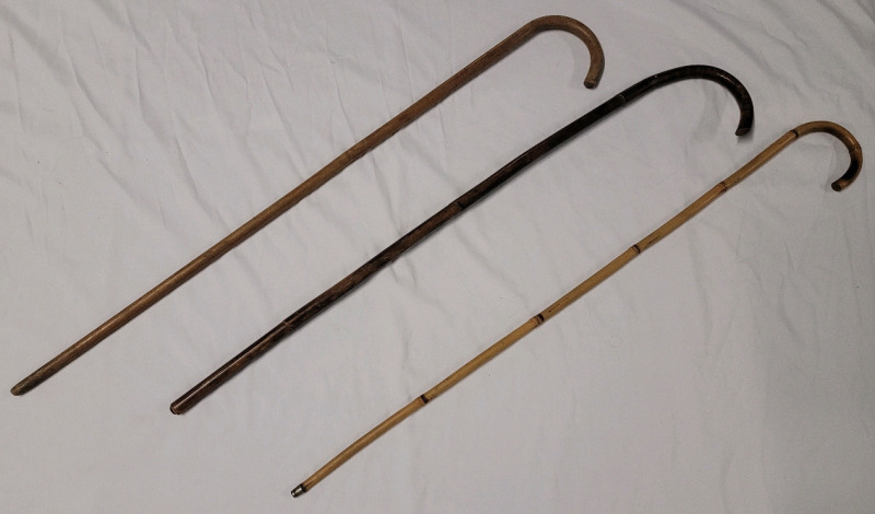 Three (3) Wooden Walking Canes . Measures 36" to 37" Tall