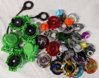 Assorted Beyblade Parts. Includes 2 Rip Cords and 5 Launchers.