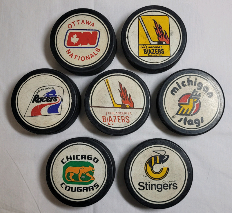 Vintage WHA Hockey Pucks , Seven (7) Pucks . Ottawa , Vancouver , Indianapolis , Philadelphia , Michigan , Chicago & Cincinnati