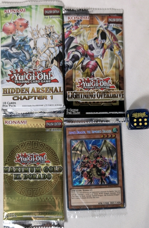 Sealed Lot Of Yu-Gi-Oh! Trading Card Packs And Dice One 1st Edition Lightning Overdrive Pack, One 1st Edition Hidden Arsenal Chapter 1 Pack, 1st Edition Maximum Gold El Dorado Pack & Armed Dragon, The Armored Dragon Promo Card