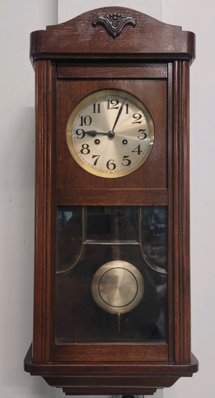 Pendulum Wind-Up Wall Clock w/Key . Measures 13 1/4"×30" . Chimes on the Hour & Half Hour , Removable Sides . Pendulum has been swinging for 10min , would benefit from service before use