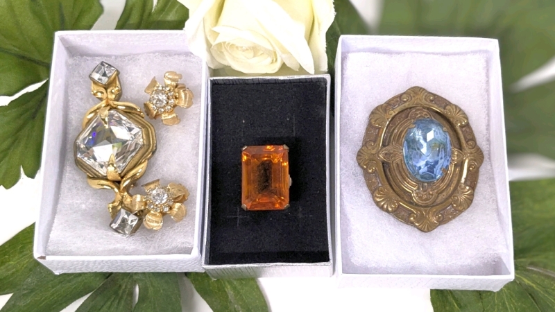 Gold Tone Size 6 Ring w Prong-Set Faceted Orange Stone, 2 Pairs Floral Stud Rhinestone Clip-On Earrings, & 2 Brooches: Large Shield w Prong-Set Light Blue Faceted Stone & Gold Tone Large Triple Stone