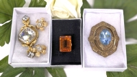 Gold Tone Size 6 Ring w Prong-Set Faceted Orange Stone, 2 Pairs Floral Stud Rhinestone Clip-On Earrings, & 2 Brooches: Large Shield w Prong-Set Light Blue Faceted Stone & Gold Tone Large Triple Stone