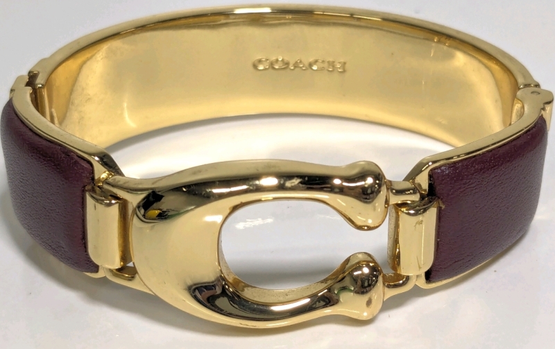 Signed COACH Gold Tone Signature Hinged Bangle Bracelet | Approx 0.75" Wide, 2.5" x 2.25"